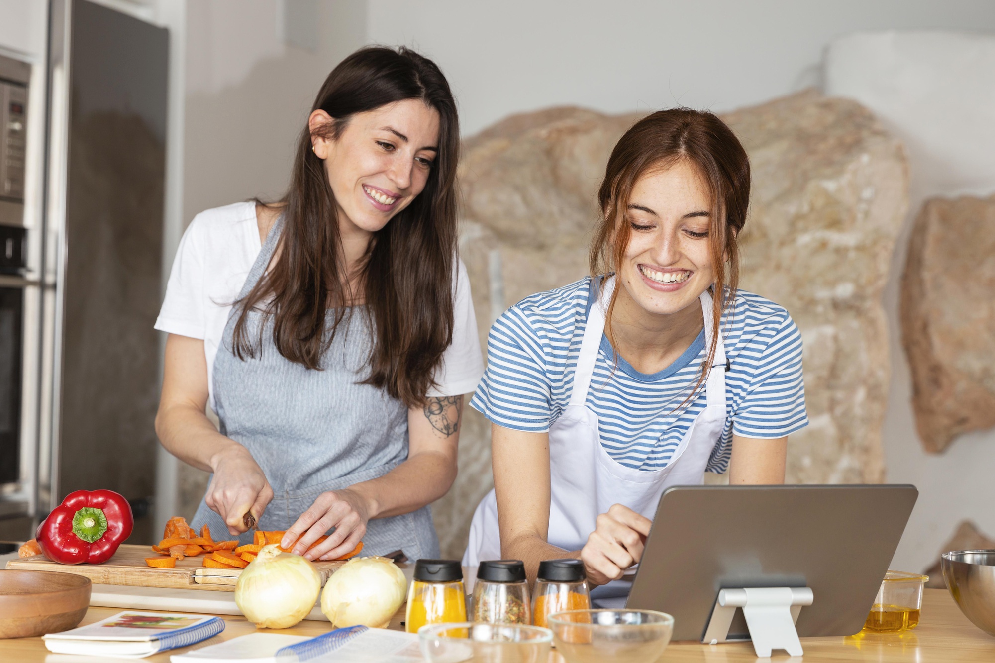 Student cooking with mentor in home kitchen